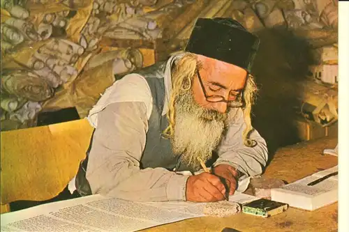 JUDAICA - a Scribe writing on goats skin the holy scroll of the law