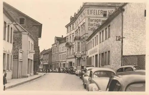 [Ansichtskarte] 5488 ADENAU, Hauptstrasse, Hotel Eifeler Hof, Oldtimer, VW - Käfer, Photo-AK Schiefen. 