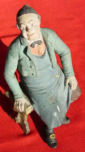 Sehr alte Terrakotta-Figur um 1900. Sitzender Mann auf Schemel, in Arbeitskleidung, mit schwarzer Kopfbedeckung. Marke auf Unterseite des Schemels : BB 4554