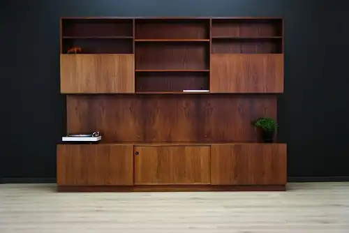 This rosewood wall unit was designed by Ib Koford-Larsen and manufactured in Faarup Møbelfabrik in Denmark in the 1970s. The piece features two cupboards (one...