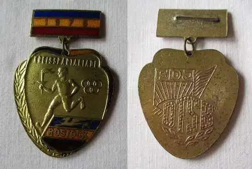 Emailliertes Abzeichen Kreisspartakiade Rostock 1976 Gold (137242)