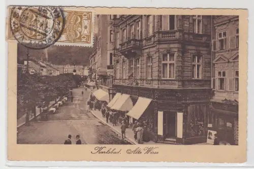 90389 Ak Karlsbad - Alte Wiese, Straßenansicht mit Geschäften, Uhrmacher 1920