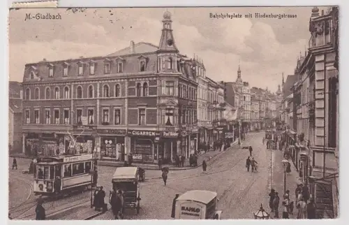 86171 Ak M.-Gladbach Bahnhofsplatz mit Handenburgstraße und vielen Geschäften