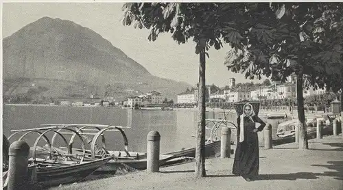 ALTE POSTKARTE LUGANO QUAI E MONTE S. SALVATORE FRAU MIT KIEPE TRACHT traditional Boot boat cpa postcard Ansichtskarte