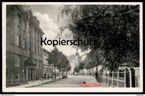 ALTE POSTKARTE GÜSTROW I. M. EISENBAHNBRÜCKE MIT BLICK AUF DIE A. H. (UNKENNTLICH) STRASSE postcard cpa Ansichtskarte
