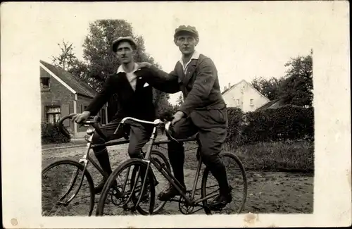 Foto Ak Zwei Männer mit Fahrrädern, Luftpumpe, Straßenpartie