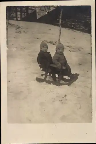 Foto Ak Zwei Kinder auf einem Schlitten, Winter