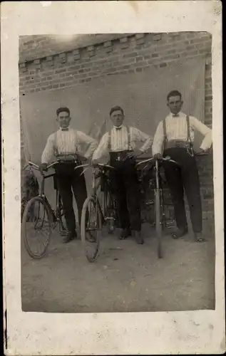 Foto Ak Drei junge Männer mit Fahrrädern