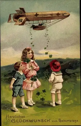 Präge Ak Glückwunsch Geburtstag, Zeppelin wirft Kleeblätter ab