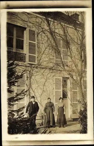 Foto Ak Saint Jean de la Ruelle Loiret, Damen und Mann vor einem Wohnhaus