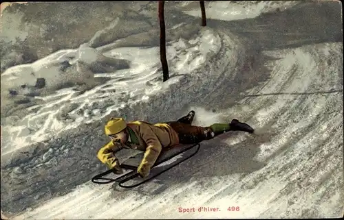 Ak Sport d'hiver, Mann auf einem Schlitten bei der Abfahrt