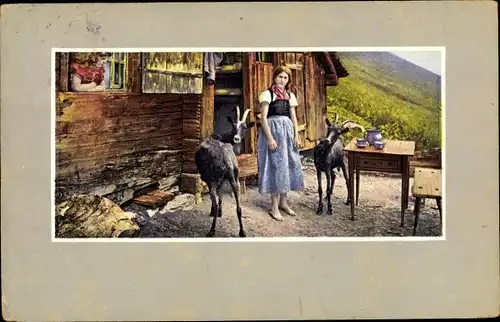 Ak Schweiz, Frau in Tracht mit Ziegen vor einer Alphütte