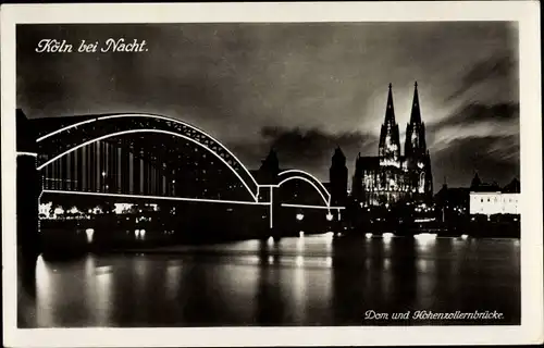 Ak Köln am Rhein, Rheinpanorama mit Dom und Hohenzollernbrücke bei Nacht