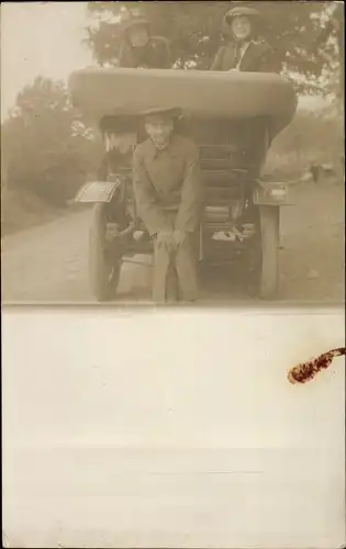 Foto Ak Mann hinter und zwei Frauen in einem Automobil mit geöffnetem Verdeck