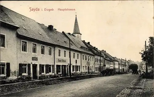 Ak Sayda im Erzgebirge, Hauptstraße, Firma Emil Ulrich, Kirche im Hintergrund