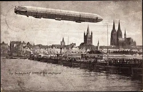 Ak Köln am Rhein, Reichsluftschiff Zeppelin über der Stadt, Schiffsbrücke, Dom