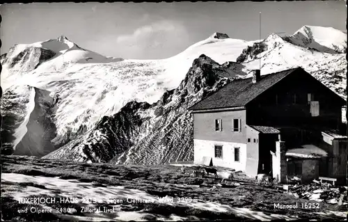 Ak Zillertal Tirol, Tuxerjoch Haus gegen gefrorene Wand und Olperer