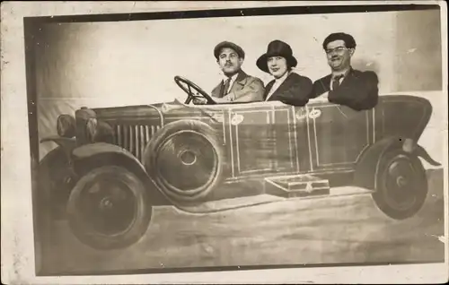 Foto Ak Zwei Männer und eine Frau in einem gemalten Automobil