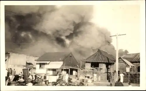 Foto Ak Philippinen ?, Brand in einem Dorf, Häuser, Rauchwolke