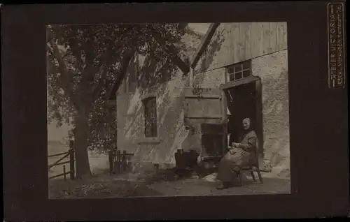 Foto Bad Oeynhausen in Westfalen, Frau in Tracht vor einem Haus