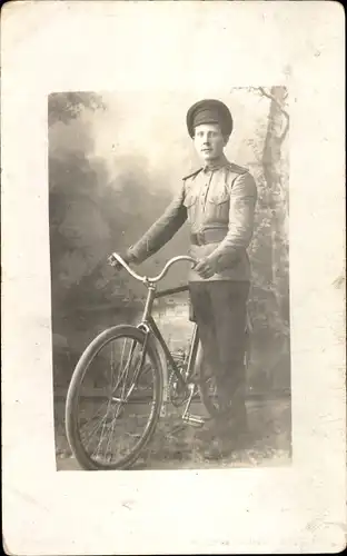 Foto Ak Russischer Offizier mit Fahrrad, Zarenreich, Standportrait, Schirmmütze