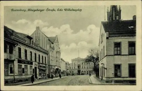 Ak Kętrzyn Rastenburg Ostpreußen, Königsberger Straße, Ecke Wilhelmsplatz, Geschäfte