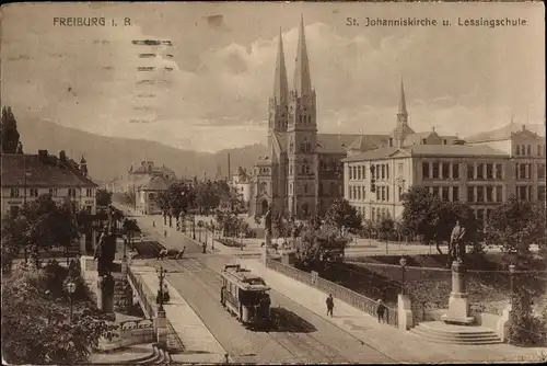 Ak Freiburg im Breisgau, St. Johanniskirche und Lessingschule, Straßenbahn