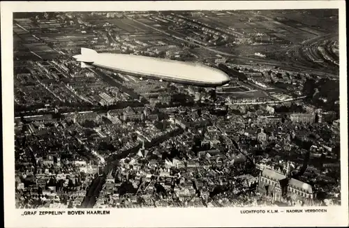 Ak Haarlem Nordholland Niederlande, Luftschiff LZ 127 Graf Zeppelin über der Stadt, Fliegeraufnahme