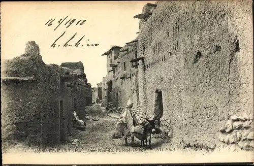 Ak El Kantara Algerien, Rue du Village, Dorfstraße, Anwohner, Esel
