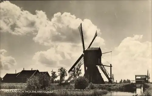 Ak Hollandsch Molenlandschap, Windmühle am Wasser, Wohnhäuser, Wolken