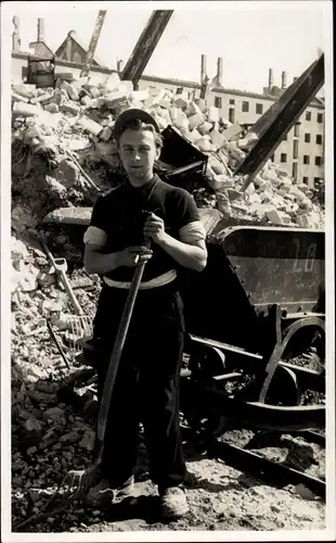 Foto Berlin, Arbeiter mit Schaufel vor einem Geröberg