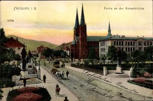 Ak Freiburg im Breisgau, Partie an der Kaiserbrücke, Kirche, Kutsche ,Straßenbahn