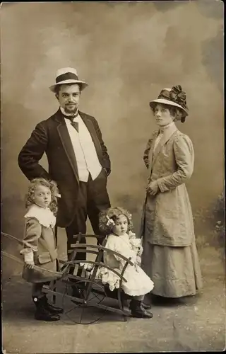 Foto Ak Familienbild, Eltern, Mädchen, Kinder, Schubkarre, Kleid, Hüte, Paris