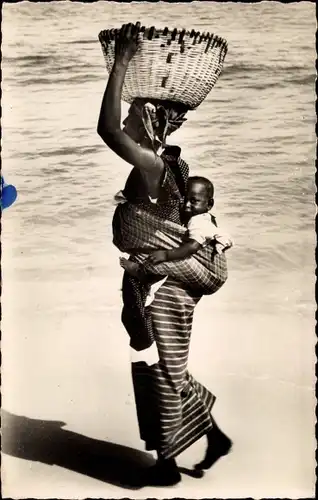 Ak Dakar Senegal, Promenade, Senegalesin mit Baby auf dem Rücken am Strand
