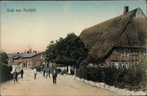 Ak Postfeld in Schleswig Holstein, Straßenpartie im Ort, Haus mit Reetdach