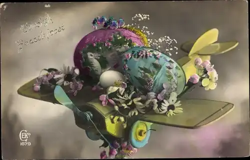 Ak Glückwunsch Ostern, Holzflugzeug mit Ostereiern und Blumen