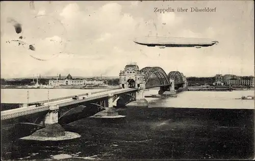 Ak Düsseldorf am Rhein, Zeppelin über der Stadt, Brücke