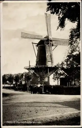 Ak Nordholland, Ortschaft mit Windmühle