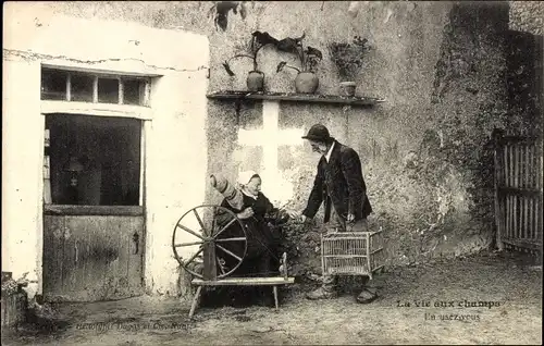Ak La vie aux champs, Frau am Spinnrad, Mann mit Vogelkäfig