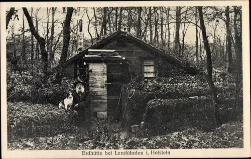 Ak Lentföhrden in Holstein, Bärtiger Mann mit Hund vor einer Erdhütte