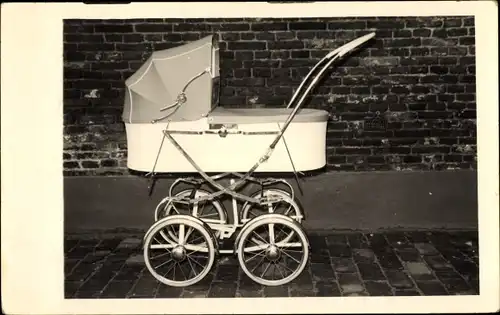 Foto Ak Kinderwagen vor einer Backsteinmauer