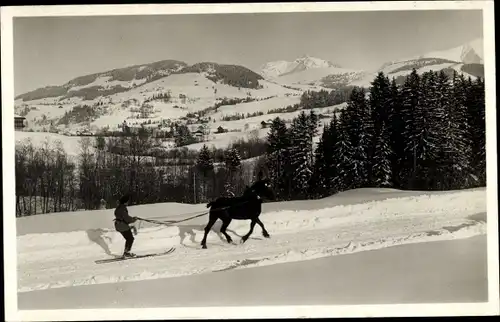 Ak Megève Haute Savoie, Ski djoering, Skifahrer lässt sich von Pferd ziehen