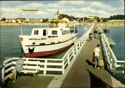 Ak Ostseebad Grömitz in Holstein, Seebrücke mit Motorschiff Wappen von Grömitz