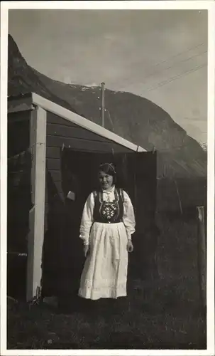 Foto Ak Mädchen in norwegischer Volkstracht, Portrait, Im Hintergrund Berge, Hochspannungsleitung