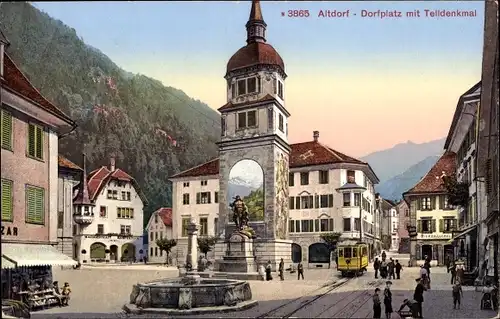 Ak Altdorf Kt. Uri Schweiz, Dorfplatz mit Telldenkmal, Brunnen, Straßenbahn