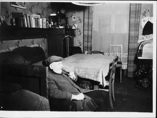 Foto Berlin ?, Alter Mann mit Pfeife im Wohnzimmer