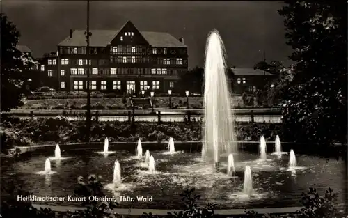 Ak Oberhof im Thüringer Wald, Gebäude, beleuchteter Springbrunnen, Nachtansicht