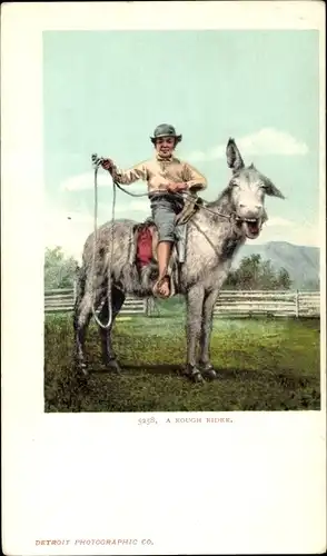 Ak USA, Junge mit Lasso auf einem Esel
