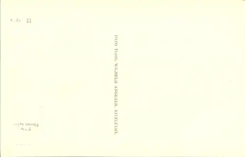 Ak Kitzbühel in Tirol, Durchblick auf Ort im Winter bei Nacht