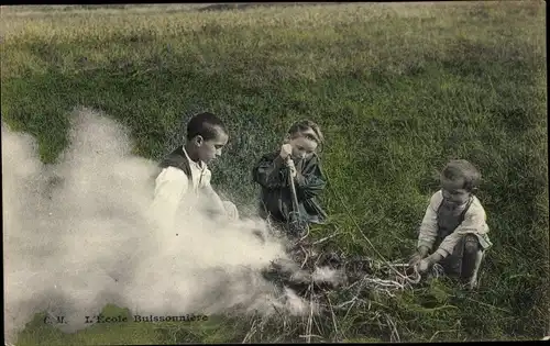Ak Kinder machen Lagerfeuer, Qualm, Wiese, Französische Tracht